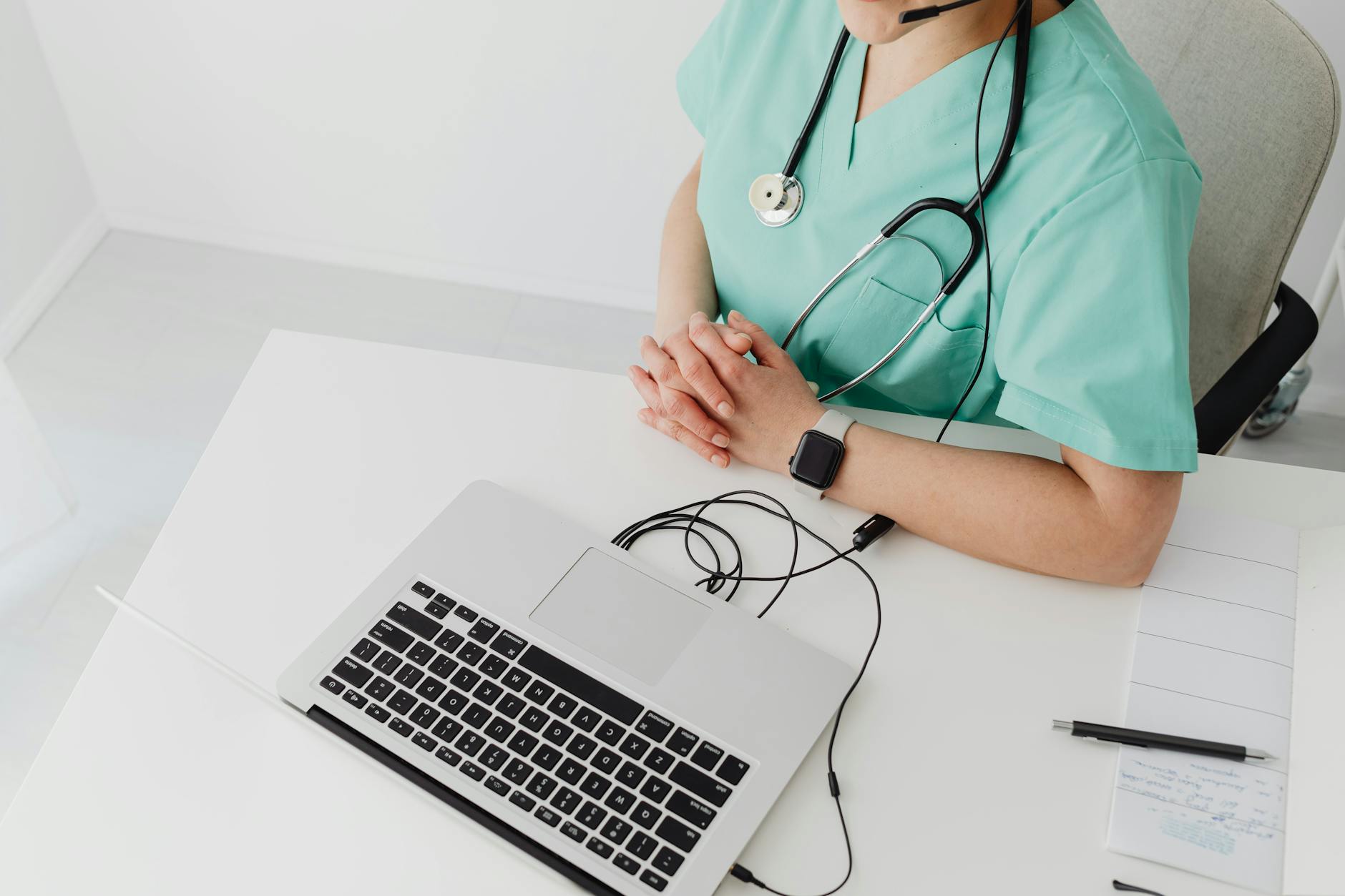 Female nurse practitioner with stethoscope at laptop for telehealth family medicine in California